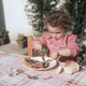 Little girl cutting into large steak with fork and knife